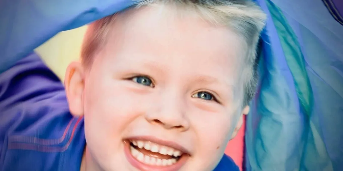 Boy smiling in a blue shirt