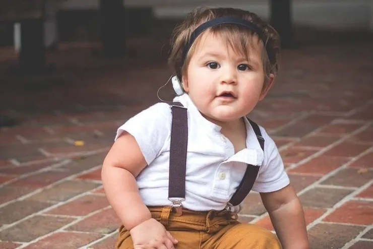 boy-wearing-hearing-device Young toddler wearing a hearing device