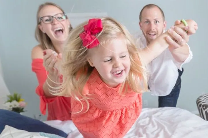 family-playing Mum and Dad playing with girl