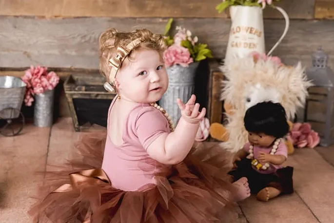 girl-microtia-tutu Baby girl in tutu wearing a hearing device