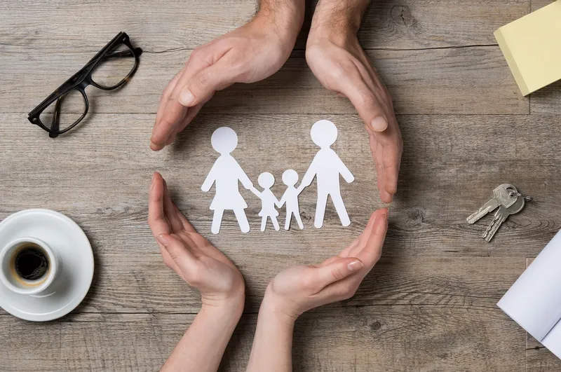microtia-community Image depicting community with hands around a paper cut-out family