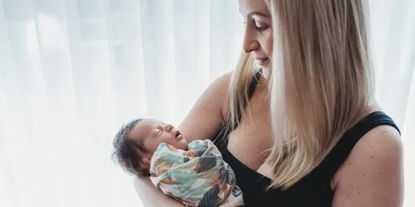 a mother holding a new baby